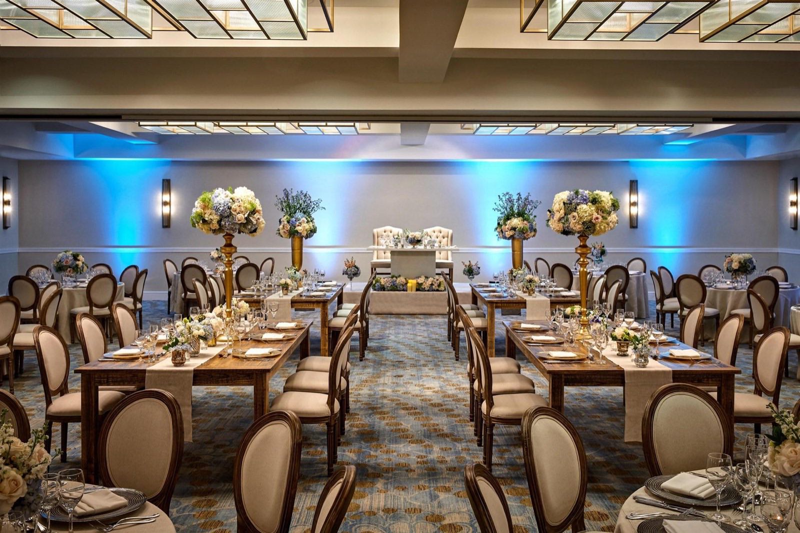 City Ballroom set for a wedding reception with uplighting and floral centerpieces